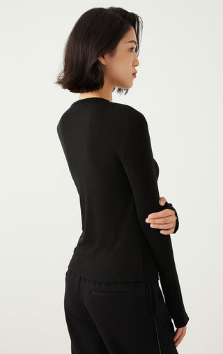 Black long-sleeve henley top in side view with curved hem and button placket