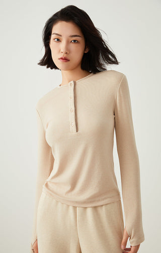 Apricot henley long-sleeve top with 3-button placket and fitted silhouette.