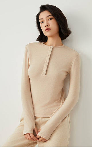 Apricot long-sleeve henley top with front button placket and kangaroo-less pullover look.