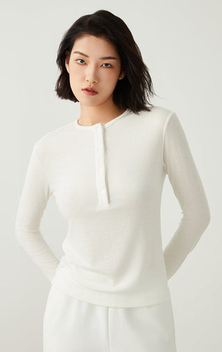 White Tencel wool henley long-sleeve top with front button placket and split collar.