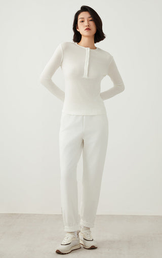 White long-sleeve henley top, front view with button placket and straight hem.