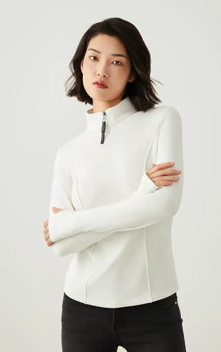 White half-zip knit top with stand collar and beaded zipper pull, side profile view