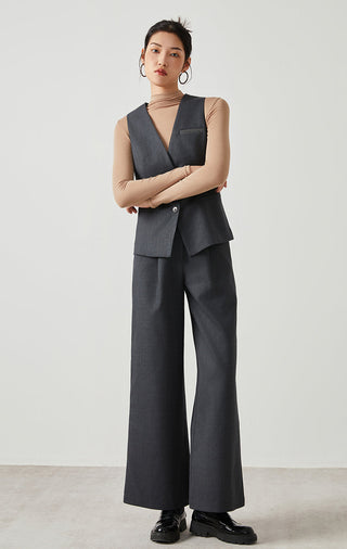 Dark gray wool-blend tailored vest with V-neck, button front, patch pockets; full outfit view