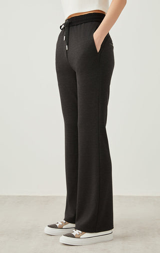 Dark gray wide-leg drawstring pants, side view with relaxed straight legs