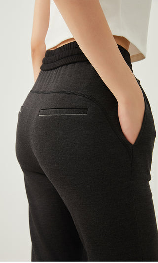 Dark gray wide-leg pants with elastic waistband and back patch pocket detail
