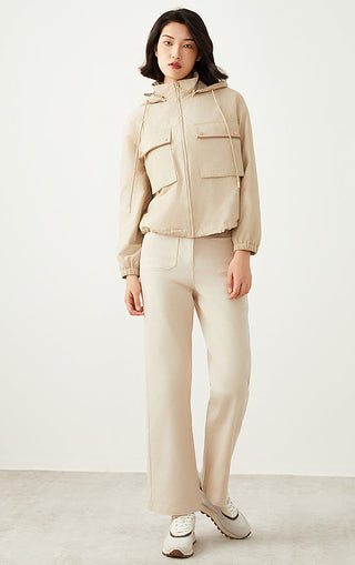 Apricot hooded utility jacket with drawstring hood, front zip, and flap pockets