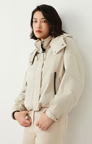 Light beige hooded puffer jacket with drawstring collar and vertical zipper pocket