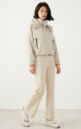 Light beige oversized hooded puffer jacket with front zipper and flap shoulder pockets