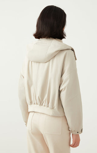 Light beige hooded puffer jacket back view with gathered hem and snap cuffs