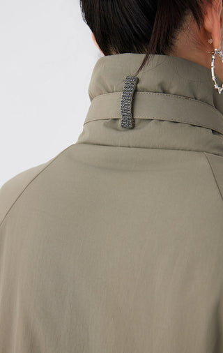 Back collar of army green utility jacket with leather strap detail and stand neck