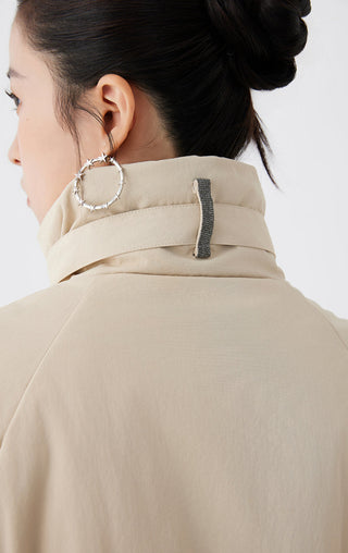 Apricot jacket back collar close-up: stand collar with leather strap detail