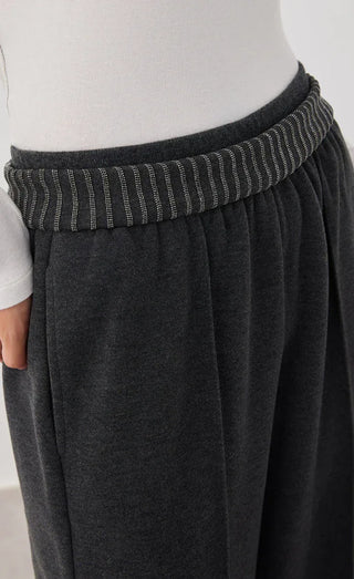 Dark gray knit pants waistband with ribbed trim and gathered elastic