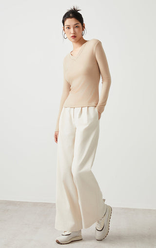 Apricot v-neck long-sleeve top with fitted bodice and ribbed neckline