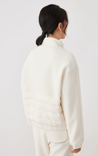 Back view of white wool zip-front jacket with elastic waist and cuff hems