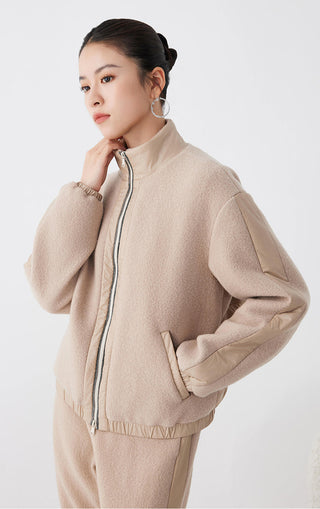 Camel zip-front jacket with standing collar, elastic cuffs, and ribbed hem