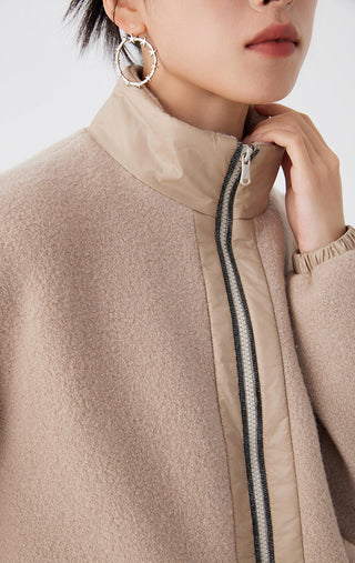 Close-up camel jacket: standing collar and center zipper with textured beaded trim