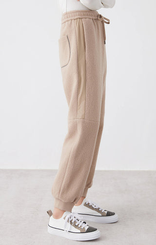 Camel knit jogger pants side view, elastic waist with drawstring and cuffed ankles