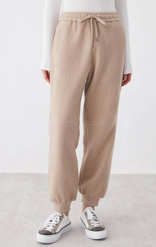 Camel knit jogger pants front view, drawstring waist and slanted front pockets