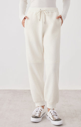 White wool drawstring knit jogger pants with ribbed waistband and tapered legs