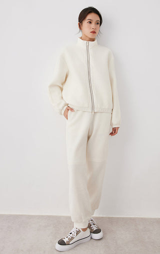 White wool drawstring jogger pants with elastic waistband and relaxed tapered fit