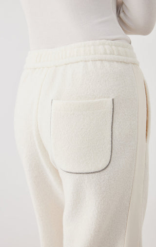 White wool jogger pants close-up of back pocket and ribbed elastic waistband