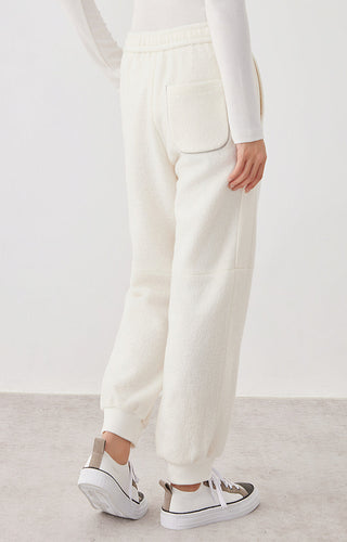 White knit jogger pants front view with slanted pockets and cuffed hem