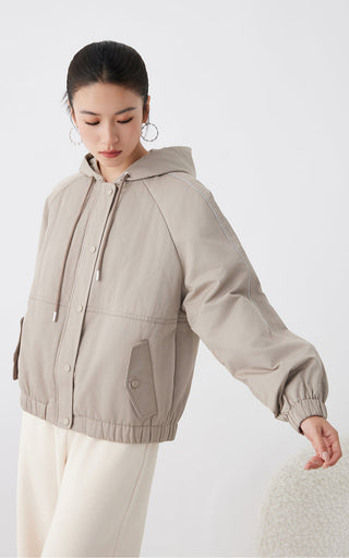 Cotton blend hooded quilted jacket, light tan, angled front view with snap buttons and hem band