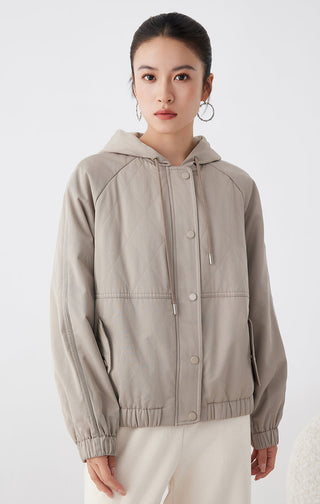 Light tan hooded quilted cotton jacket, front view with snap placket, drawcord hood, ribbed cuffs