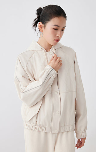 Creamy light tan hooded quilted cotton blend jacket, front view with drawcord and snap buttons