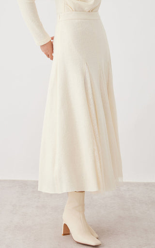 Beige panelled midi skirt with stitched panels and lace overlay along the hem
