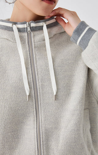 Close-up: light gray wool hooded zip jacket with white drawstrings and zip pull