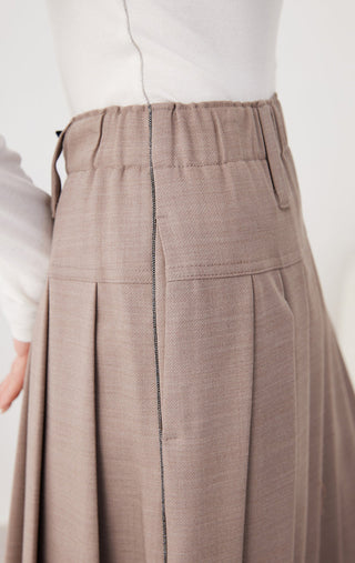 Dark camel skirt detail: elastic waistband with pleats and front seam panels