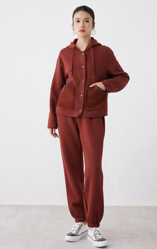 Red zip-up style hooded jacket with button front and chest pocket panels, full view