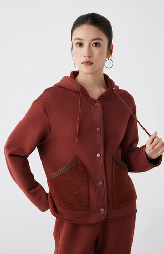 Red hooded jacket showing drawstring ties, button closure, and chest pocket panels