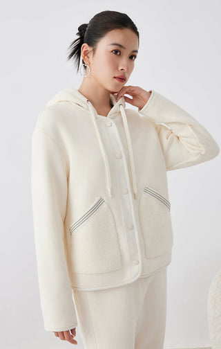 Cream hooded jacket with button placket, drawstring ties, and textured chest pockets