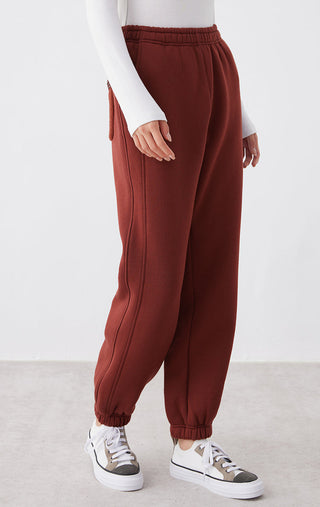 Ankela Red relaxed-fit pants, side view with elastic waist and tapered jogger shape
