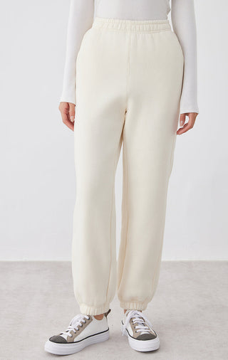 Cream White relaxed-fit pants from front with elastic waist and ankle cuffs