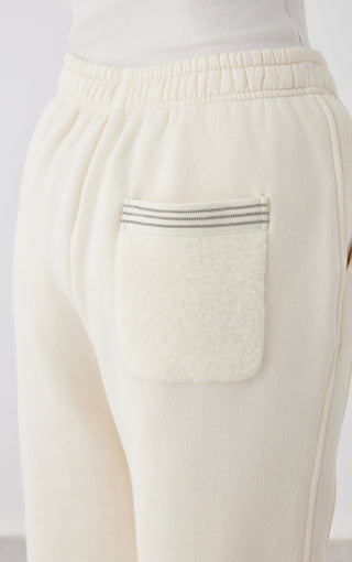 Cream White pants back patch pocket with striped trim and elastic waistband