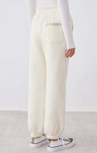 Cream White relaxed-fit pants with front patch pocket and elastic ankle cuffs
