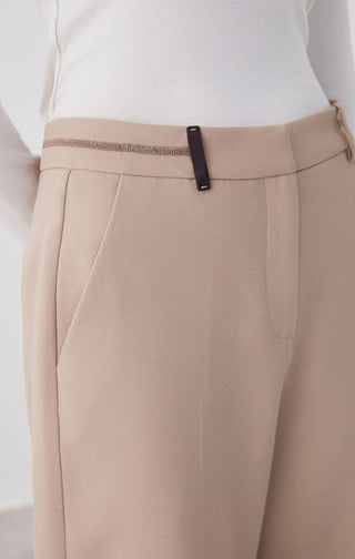 Camel pants waistband close-up with black belt detail and belt loops