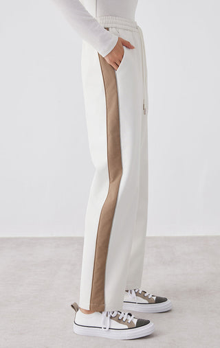 White wide-leg pants with tan side stripe and side hand pocket opening