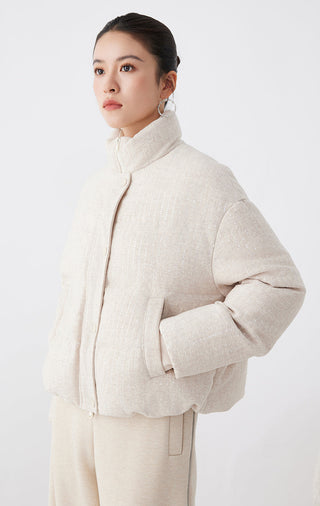 Beige shimmer down jacket, side view with high neck and button placket