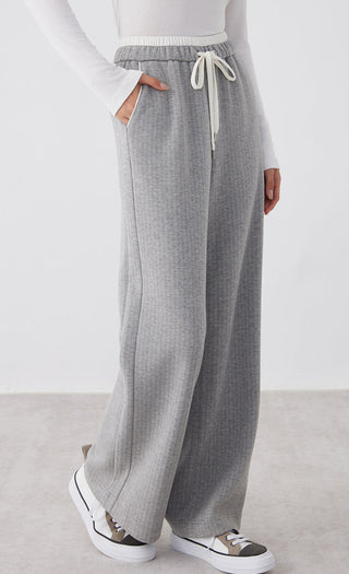 Light gray wide-leg pants with elastic waist and drawstring; long straight leg