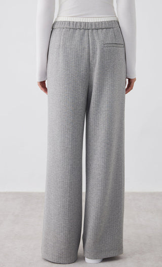 Light gray wide-leg pants with side pocket detail and elastic drawstring waist
