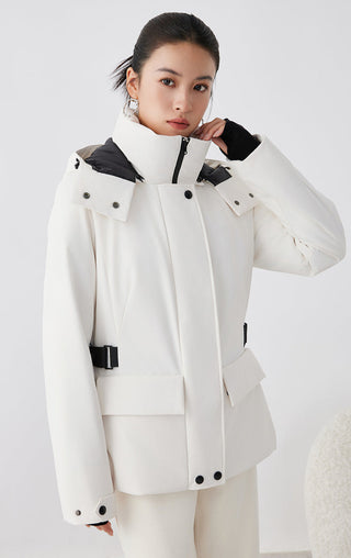 White winter parka with high collar, black-trim snap buttons, utility pocket and belt