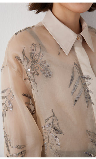 Close-up of camel silk shirt: silver-thread leaf embroidery on sheer fabric