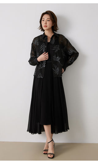 Black embroidered silk button shirt with silver-thread leaf detailing, worn over a skirt