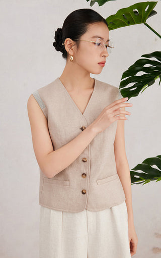Camel sleeveless vest with V-neckline, gold button front, and flap pockets