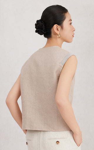 Back view of camel sleeveless vest with V-back and textured shoulder seam