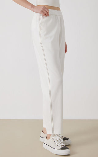 White tailored pants with elastic waistband and long, slim tapered leg